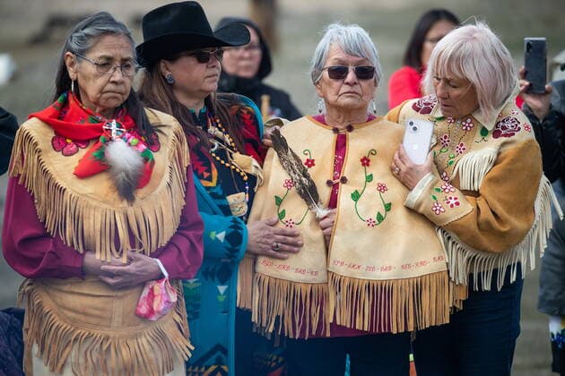March 30, 2022, WILLIAMS LAKE, BC, CANADA: Women listen as Prime Minister Justin Trudeau speaks during a visit to the former grounds of St. Joseph s Mission Residential School, in Williams Lake, B.C., on Wednesday, March 30, 2022. In January, the Williams Lake First Nation announced it had identified 93 reflections that could indicate the number of children buried around the site of the former residential school. WILLIAMS LAKE CANADA  - ZUMAc35_ 20220330_zaf_c35_116 Copyright: xDarrylxDyckx