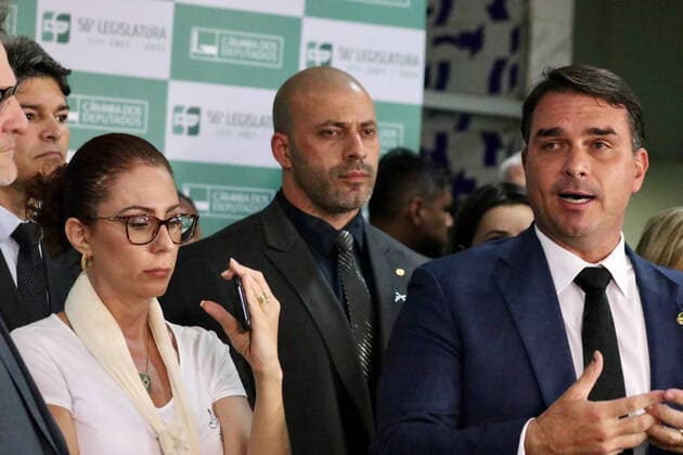 March 30, 2022, Brasilia, Federal District, Brazil: Senator Flavio Bolsonaro gives a press conference alongside federal deputy Daniel Silveira to talk about the decision of Minister Alexandre de Moraes, of the Federal Supreme Court, which determined that the deputy return to use the electronic anklet. During his speech, the son of President Jair Bolsonaro also appealed for something to touch the heart of the STF minister and stressed, in his speech, that Silveira has always been a good guy.  Copyright: xFredericoxBrasilx