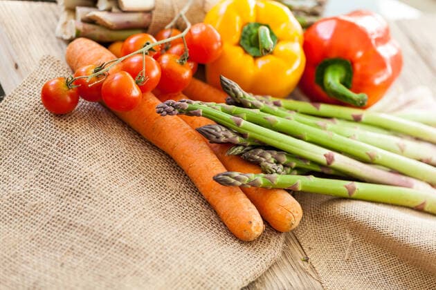 Fresh vegetables in a country kitchen with green asparagus spears,, cherry tomatoes on the vine, sweet bell peppers and carrots lying an hessian waiting to be prepared for dinner, model released, , property released, , 13982930.jpg, asparagus, cooking, ingredient, produce, shoots, spears, uncooked, vegetable, vegetarian, food, fresh, green, healthy, tips, vegan, bell pepper, capsicum, carrots, sweet pepper, tomato, vine, culinary, kitchen, preparation, rustic, whole, burlap, hessian, cherry tomato, nutrition,