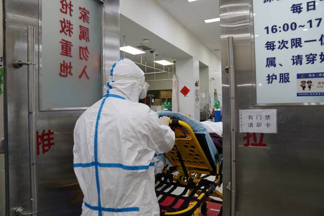 (220402) -- SHANGHAI, April 2, 2022 -- An emergency staffer carries a patient into an emergency treatment room of Ruijin Hospital in east China s Shanghai, April 1, 2022. Ruijin Hospital has been optimizing its emergency services amid the latest COVID-19 resurgence in Shanghai. More personnel have been assigned to reinforce the emergency capability. ) CHINA-SHANGHAI-HOSPITAL-EMERGENCY CENTER (CN) YuanxQuan 