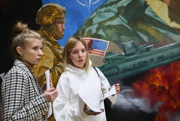 MOSCOW, RUSSIA - APRIL 4, 2022: People attend the exhibition NATO: The Chronicle of Cruelty at the State Central Museum of Contemporary History of Russia. Anton Novoderezhkin TASS  TS12B00C