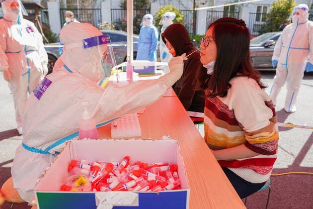 (220404) -- SHANGHAI, April 4, 2022 -- A medical worker from east China s Jiangsu Province takes a swab sample from a resident for nucleic acid test at a community in Pudong New Area of east China s Shanghai, April 4, 2022. Amid rising numbers of COVID-19 infections in its latest resurgence, Shanghai on Monday launched a citywide nucleic acid testing campaign covering the city s more than 24 million residents. ) CHINA-SHANGHAI-COVID-19-CITYWIDE TESTING (CN) DingxTing 