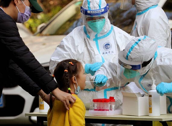 (220404) -- SHANGHAI, April 4, 2022 -- A medical worker from east China s Zhejiang Province takes a swab sample from a child for nucleic acid test at a community in Songjiang District of Shanghai, east China, April 4, 2022. Amid rising numbers of COVID-19 infections in its latest resurgence, Shanghai on Monday launched a citywide nucleic acid testing campaign covering the city s more than 24 million residents. ) CHINA-SHANGHAI-COVID-19-CITYWIDE TESTING (CN) LiuxYing 