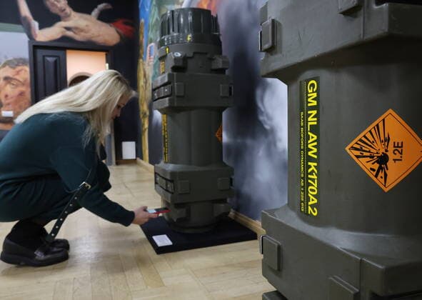 MOSCOW, RUSSIA - APRIL 4, 2022: A visitor takes pictures of launching transporting containers for NLAW lightweight anti-tank missile systems on display at the exhibition NATO: The Chronicle of Cruelty at the State Central Museum of Contemporary History of Russia. Anton Novoderezhkin TASS  TS12B073