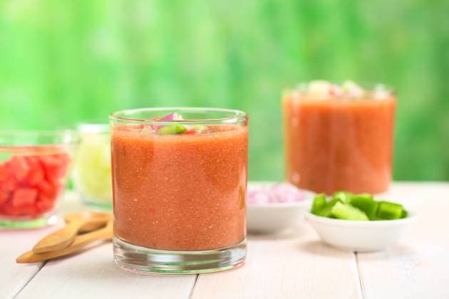 Traditional Spanish cold vegetable soup made of tomato, cucumber, bell pepper, onion, garlic and olive oil served in glasses (Selective Focus, Focus on the front of the glass rim) , 10068568.jpg, gazpacho, soup, cold, vegetable, vegetarian, vegan, cold soup , vegetable soup , tomato, pepper, bell pepper , capsicum, cucumber, onion, red, red onion , blended, pureed, puree, raw, chopped, food, appetizer, fresh, refreshing, refreshment, starter, entree, drink, beverage, snack, smoothie, fluid, nutrition, diet, Andalusian, Spanish, Mediterranean, Andalusian cuisine , Andalusian cooking , Spanish cuisine , Spanish cooking , Mediterranean cuisine , Mediterranean cooking , healthy, homemade, prepared, served, glass, garnish, piece, cop