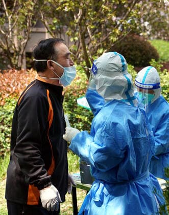 (220406) -- SHANGHAI, April 6, 2022 -- A medical worker takes a swab sample from a resident for nucleic acid test at a community in Songjiang District of Shanghai, east China, April 6, 2022. Shanghai on Wednesday launched another round of citywide antigen and nucleic acid testing amid efforts to contain the recent resurgence of COVID-19 cases in the metropolis, according to local authorities. The decision was made based on the results of mass nucleic acid testing on Monday, according to the Shanghai municipal leading group for COVID-19 prevention and control. ) CHINA-SHANGHAI-COVID-19-TEST (CN) LiuxYing 