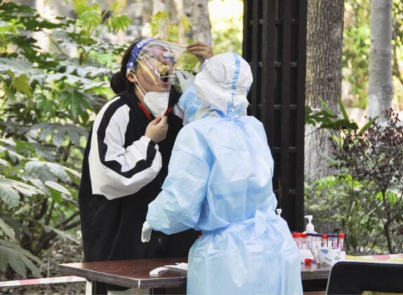 Continued COVID-19 lockdown in Shanghai A resident of a condominium takes a PCR test on its premises in Shanghai on April 7, 2022, amid a continued COVID-19 lockdown in the Chinese city.  A14AA0001277259P