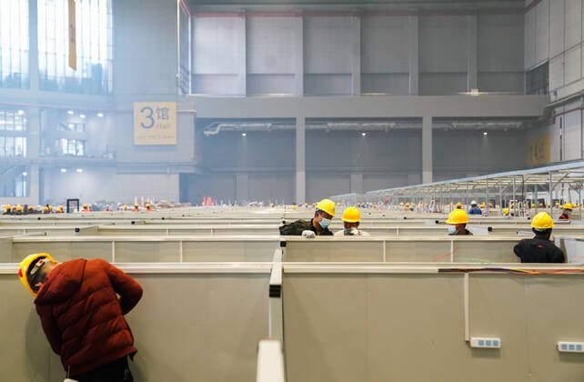 (220407) -- SHANGHAI, April 7, 2022 -- People work at the National Exhibition and Convention Center in east China s Shanghai, April 7, 2022. Shanghai is converting the National Exhibition and Convention Center (NECC) into a makeshift hospital with a planned capacity of 40,000 beds. Upon completion, it is expected to act as the biggest such hospital for those testing positive for COVID-19 in the metropolis. ) CHINA-SHANGHAI-NECC-MAKESHIFT HOSPITAL (CN) DingxTing 