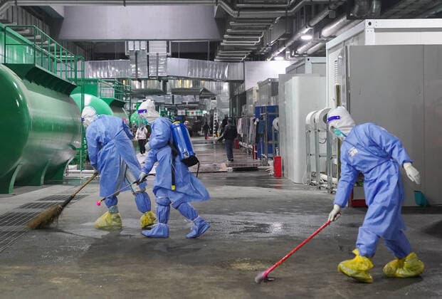 (220414) -- SHANGHAI, April 14, 2022 -- Medical workers clean and disinfect the floor at the National Exhibition and Convention Center (NECC), the largest makeshift hospital, in east China s Shanghai, April 14, 2022. A total of 322 COVID-19 patients were released from medical observation and left the NECC on Thursday morning, local authorities said. They were the first batch of patients discharged from the NECC since it started admitting COVID-19 mild cases and asymptomatic carriers on April 9, according to the municipal epidemic control office. The convention center-turned makeshift hospital has a capacity to accommodate more than 50,000 beds. ) CHINA-SHANGHAI-MAKESHIFT HOSPITAL-COVID-19 PATIENTS-RELEASE(CN) DingxTing 