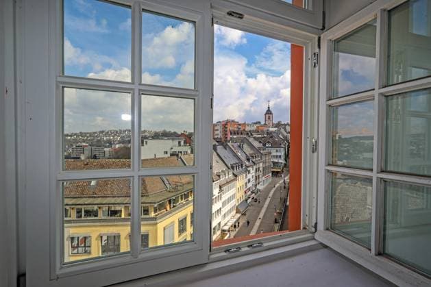 Blick aus einem Fenster auf die Universitaetsstadt Siegen (Oberstadt) mit ihrem Wahrzeichen (dem Kroenchen auf der Nikolaikirche, rechts). Blick auf die Oberstadt am 14.04.2022 in Siegen Deutschland. *** View from a window on the university town Siegen Oberstadt with its landmark the Kroenchen on the Nikolaikirche, right view on the Oberstadt on 14 04 2022 in Siegen Germany