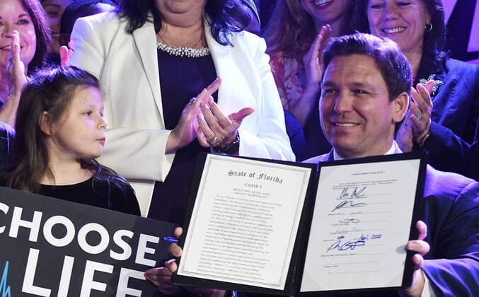 April 14, 2022, Kissimmee, Florida, United States: Governor Ron DeSantis signs Florida™s 15-week abortion ban into law at Nacion de Fe church in Kissimmee. The law, which goes into effect July 1, bans the procedure after 15 weeks of pregnancy without exemptions for rape, incest or human trafficking, but does allow exemptions in cases where a pregnancy is serious risk to the mother or a fatal abnormality is detected if two physicians confirm the diagnosis in writing. Kissimmee United States - ZUMAs197 20220414_zaa_s197_109 Copyright: xPaulxHennessyx