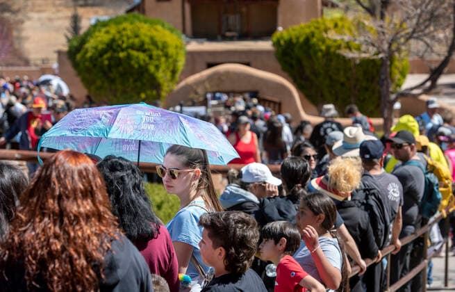 April 15, 2022, USA: Courtney Beeman, her nephew Arian Sanchez, 8, and other family members, all from Farmington, wait with hundreds of others to enter the Santuario de Chimayo after their Good Friday Pilgrimage. After two years of almost no Good Friday Pilgrimage thousands made the treck this year to the northern New Mexico church, Friday April 15, 2022. USA - ZUMAab1_ 20220415_zaf_ab1_024 Copyright: xEddiexMoorex