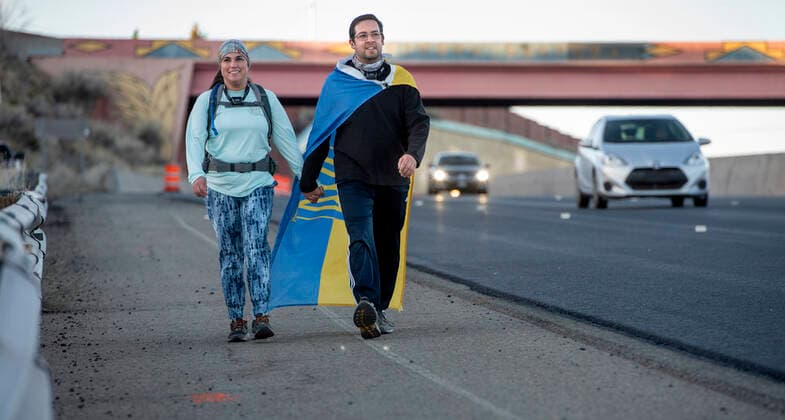 April 15, 2022, USA: Therese and James Sedillo, wearing a Ukraine flag, from Albuquerque, make their Good Friday Pilgrimage to the Santuario de Chimayo, Friday April 15, 2022. After two years of almost no pilgrimage due to COVID-19, thousands made the treck to the northern New Mexico church this year. USA - ZUMAab1_ 20220415_zaf_ab1_026 Copyright: xEddiexMoorex