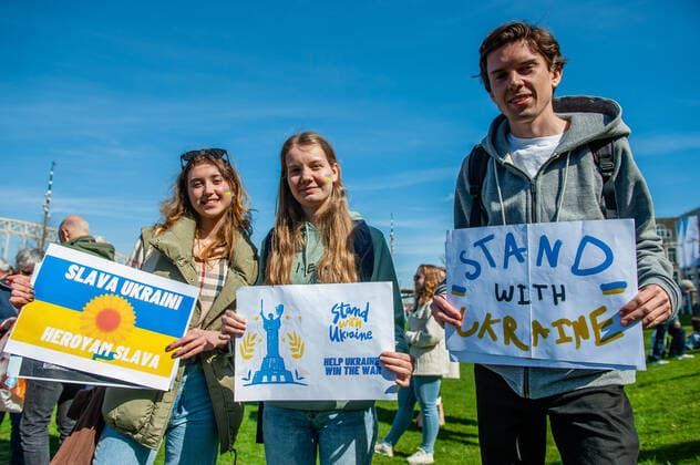 April 16, 2022, Nijmegen, Gelderland, Netherlands: A group of people seen holding placards in support of Ukraine. Under the motto, music connects people , the Nijmegen musician Mart Heijmans brought together 400 musicians at the Waalkade to sing the Ukrainian national anthem and other songs to show their solidarity with Ukraine. Around 250 of them were Ukrainian refugees received during the last months in the city. Four Ukrainian singers who have fled, including an opera singer, performed a few more songs before an attentive and emotional crowd. Nijmegen Netherlands - ZUMAs197 20220416_zaa_s197_065 Copyright: xAnaxFernandezx