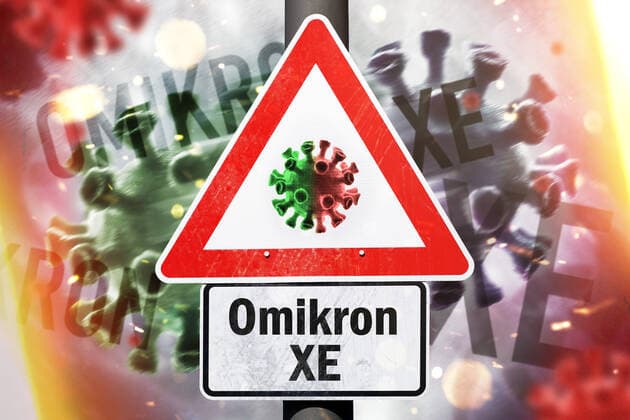 FOTOMONTAGE, Gefahrenschild mit Coronavirus-Symbol und Aufschrift Omikron XE, Omikron-Variante XE *** PHOTOMONTAGE, danger sign with coronavirus symbol and inscription Omikron XE, Omikron variant XE. ** NUR FUER REDAKTIONELLE ZWECKE ** EDITORIAL USE ONLY **