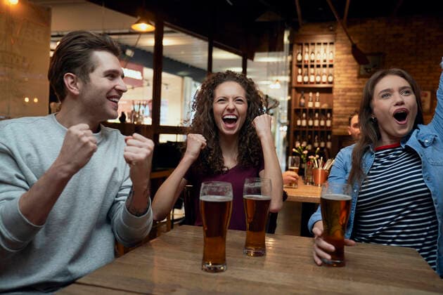 Cheerful soccer fans having beer and watching a match together in a pub model released, Symbolfoto property released, ABIF01701