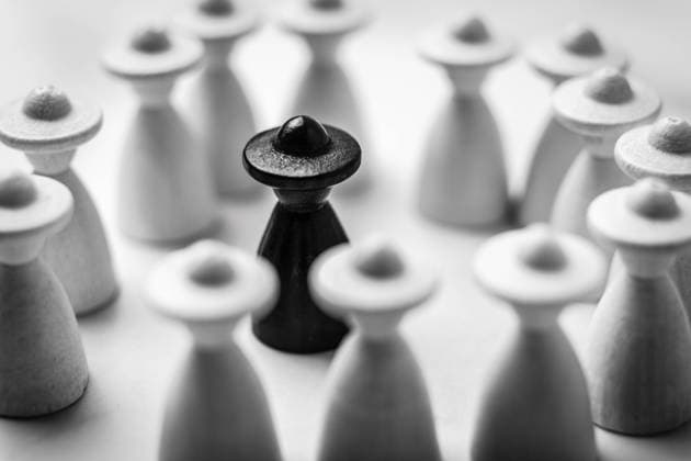 23 April 2022: exclusion and discrimination of a person, symbol picture wooden game pieces, bullying and mental health *** Ausgrenzung und Diskriminierung einer Person, Symbolbild Spielfiguren aus Holz, Mobbing und Mentale Gesundheit