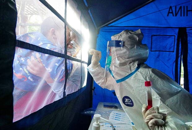 (220426) -- BEIJING, April 26, 2022 -- A medical worker takes a swab sample from a boy at a nucleic acid testing site during a mass testing for COVID-19 in Fengtai District, Beijing, capital of China, April 26, 2022. Beijing will conduct three rounds of nucleic acid testing in 11 areas from Tuesday to Saturday in efforts to curb the risk of COVID-19, local authorities said at a press conference Monday. The testing will cover people in the districts of Xicheng, Dongcheng, Haidian, Fengtai, Shijingshan, Fangshan, Tongzhou, Shunyi, Changping, Daxing and Beijing Economic-Technological Development Area, said Xu Hejian, spokesperson of the municipal government of Beijing. ) CHINA-BEIJING-COVID-19-NUCLEIC ACID TEST-EXPANSION (CN) LixXin 