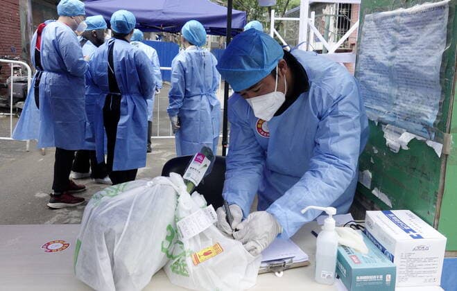 (220428) -- BEIJING, April 28, 2022 -- Community workers pick parcels for residents in a community in Chaoyang District of Beijing, capital of China, April 28, 2022. During the latest resurgence of COVID-19 infections in Beijing, people from different walks of life have joined the fight against the coronavirus, working against the clock to offer hearty support. ) CHINA-BEIJING-COVID-19 (CN) LixXin 