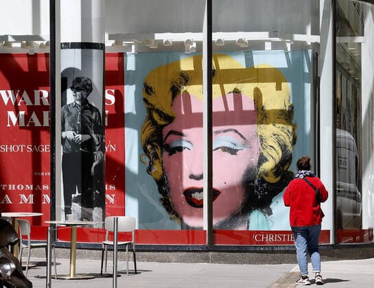 A poster of Shot Sage Blue Marilyn by Andy Warhol is on display through a window outside of Christie s 20th and 21st Century Art press preview on Friday, April 29, 2022 at Christie s in New York City.  NYP20220429101 JohnxAngelillo