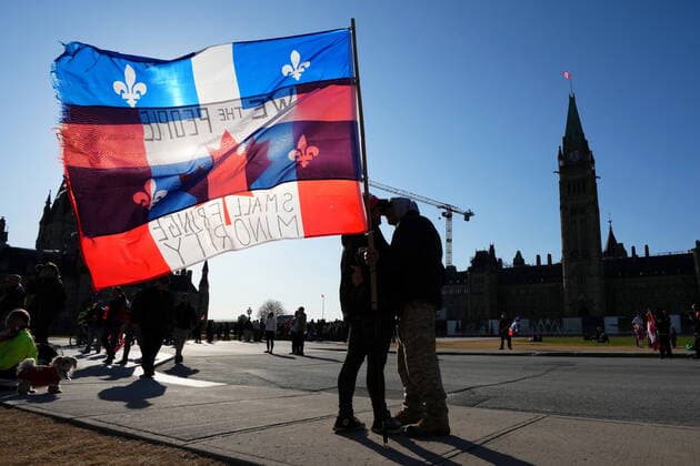 April 29, 2022, Ottawa, ON, CANADA: Protesters embrace while holding Canadian and Quebec flags during a demonstration, part of a convoy-style protest participants are calling Rolling Thunder , in Ottawa, Friday, April 29, 2022. Ottawa CANADA  - ZUMAc35_ 20220429_zaf_c35_075 Copyright: xSeanxKilpatrickx