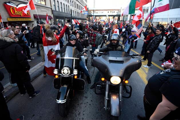 April 29, 2022, Ottawa, ON, CAN: People stand among motorcyclists revving their engines on Rideau Street during a demonstration, part of a convoy-style protest participants are calling Rolling ThunderöÄÃ¹, in Ottawa, on Friday, April 29, 2022. Ottawa CAN  - ZUMAc35_ 20220429_zaf_c35_098 Copyright: xJustinxTangx