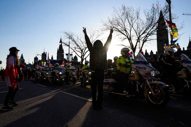April 29, 2022, Ottawa, ON, CAN: A participant cheers as police motorcycles prepare to ride off Wellington Street ahead of a march, during a demonstration, part of a convoy-style protest participants are calling Rolling ThunderöÄÃ¹, in Ottawa, on Friday, April 29, 2022. Ottawa CAN  - ZUMAc35_ 20220429_zaf_c35_103 Copyright: xJustinxTangx