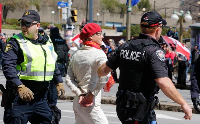 April 30, 2022, Ottawa, ON, Canada: Police arrest a person taking part in a demonstration, part of a convoy-style protest participants are calling Rolling Thunder , in Ottawa, on Saturday, April 30, 2022. Ottawa Canada  - ZUMAc35_ 20220430_zaf_c35_046 Copyright: xPatrickxDoylex