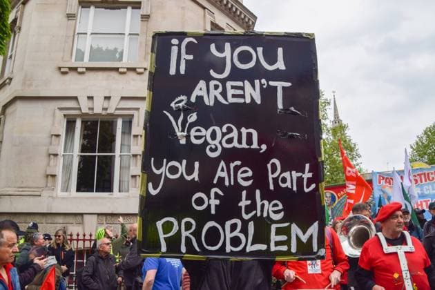 May 1, 2022, London, England, United Kingdom: A protester holds a vegan placard during the May Day march in Clerkenwell. Various unions and groups marched through central London in solidarity with workers, and for trade union rights and human rights. London United Kingdom - ZUMAv130 20220501_zip_v130_003 Copyright: xVukxValcicx