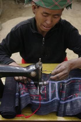 IMAGO Cultures of the world, Schwarze Hmong in Nordvietnam Black Hmong woman at her sewing machine. It is installed in front of his home. His hands are blue dyeing fabrics she sews. This machine is the sole property of the couple., model released, , 2582189.jpg, Woman, female, ethnic, ethnicity, ethnic group, minority, tribe, hill tribe, Black Hmong, sewing, sewing machine, headdress, clothes, clothing, fashion, mode, dress, costume, typical, poverty, folk, ethnically, portrait, traditional, work, sell, Asia, Vietnam,