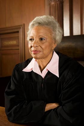 Female judge sitting in court portrait, model released, , property released, , 10051676.jpg, Indoors,Portrait,Half-Length,people,Sitting,Uniform,Middle-Aged Woman,Blacks,Grey Hair,Looking Away,55-60 Years,Confidence,Pride,Contemplation,Authority,Order,Justice,Posture,hands crossed,Legal,Law,Court,Judge,Defense,judgment,1 Person,Court Room,Court Judge, California
