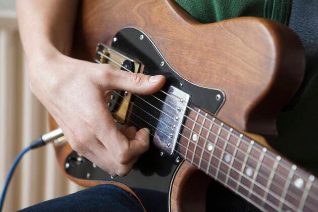 Young man strums chord on guitar, model released, , property released, , 10116186.jpg, Day,Hand,Young Adult,Indoors,Music,Adult,Man,pastime,leisure activity,one person,Guitar,Musician,Caucasian,Wooden,young man,inside,Human Hand,Guitarist,Strumming,playing an instrument,close up,Hobby,Thumb,one man,Guitar Amplifier, London