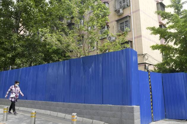 COVID-19 fears in Beijing A fence is set up around a condominium in Beijing on May 9, 2022, to block access to a residential area amid growing fears of COVID-19 cases.  A14AA0001288009P