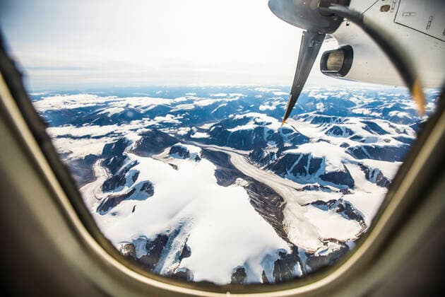 aerial view of Glaciers and mountains out a plane window. Iqaluit, Nunavut, Canada CR_JDIP210729C-321040-01