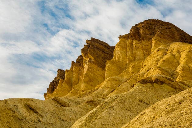 Creative Highlights World Golden Canyon cliffs in Death Valley USA , 15823138.jpg, California, canyon, cliffs, Clouds, daytime, Death Valley National Park, Desert, dry, erosion, geography, geology, Golden Canyon, gravel, landscape, mountains, nature, nobody, outdoor, peaks, rugged, sand, sky, southwest, steep, USA,