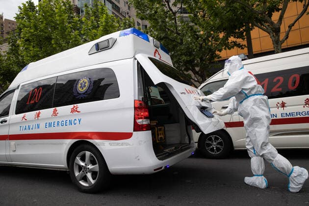 (220510) -- SHANGHAI, May 10, 2022 -- Meng Xiangjun checks equipment of an ambulance at the headquarters of a medical emergency team on Caoyang Road in east China s Shanghai, May 9, 2022. A medical emergency team consisting of 108 members with 50 ambulances from north China s Tianjin has arrived at Shanghai to assist in the city s public medical emergency service amid the COVID-19 resurgence. ) CHINA-SHANGHAI-MEDICAL TEAM-COVID-19-AID (CN) JinxLiwang 
