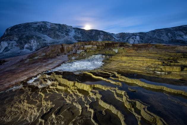 Creative Highlights World A full moon rises over Mammoth Hot Springs in Yellowstone Nation United States, Wyoming, Lake CR_GASU220511-975803-01