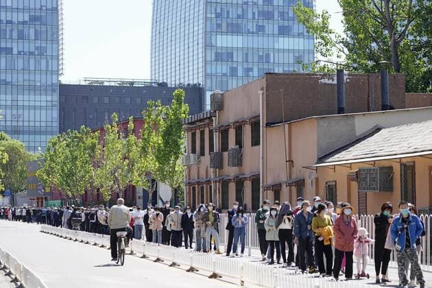 China s coronavirus battle People wait in line for mass COVID-19 testing in Beijing on May 13, 2022, as China maintains strict coronavirus controls.  A14AA0001289338P