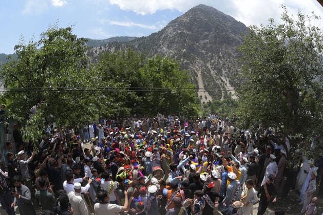 Pakistan: Chilmjushi Festival in the Kalsh Valley Kalashi women and men wearing traditional dresses participating in the dance during the Chilmjushi Festival in the Kalsh Valley. Chilum Joshi is also known as a Kalash spring festivals. Dressed up in newly knitted clothes with elaborate headgear and jewelry in vibrant colors , Kalasha women dance to traditional drumbeats during the chilum joshi festivals that concluded here at the scenic Bamburet valley on Sunday with fanfare. The four days event attracted an unprecedented number of tourists including a group of 22 Malaysian motorcyclists, besides the French, Australian and Italian nationals, on the concluding day of the festival young men women select their life partners while each day f Copyright: RanaxSajidxHussain