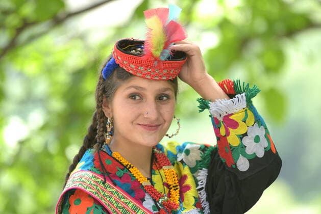 Pakistan: Chilmjushi Festival in the Kalsh Valley Kalashi women and men wearing traditional dresses participating in the dance during the Chilmjushi Festival in the Kalsh Valley. Chilum Joshi is also known as a Kalash spring festivals. Dressed up in newly knitted clothes with elaborate headgear and jewelry in vibrant colors , Kalasha women dance to traditional drumbeats during the chilum joshi festivals that concluded here at the scenic Bamburet valley on Sunday with fanfare. The four days event attracted an unprecedented number of tourists including a group of 22 Malaysian motorcyclists, besides the French, Australian and Italian nationals, on the concluding day of the festival young men women select their life partners while each day f Copyright: RanaxSajidxHussain