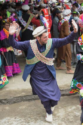Pakistan: Chilmjushi Festival in the Kalsh Valley Kalashi women and men wearing traditional dresses participating in the dance during the Chilmjushi Festival in the Kalsh Valley. Chilum Joshi is also known as a Kalash spring festivals. Dressed up in newly knitted clothes with elaborate headgear and jewelry in vibrant colors , Kalasha women dance to traditional drumbeats during the chilum joshi festivals that concluded here at the scenic Bamburet valley on Sunday with fanfare. The four days event attracted an unprecedented number of tourists including a group of 22 Malaysian motorcyclists, besides the French, Australian and Italian nationals, on the concluding day of the festival young men women select their life partners while each day f Copyright: RanaxSajidxHussain