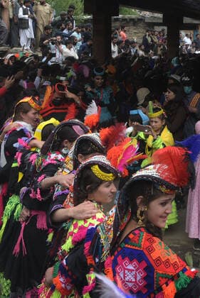 Pakistan: Chilmjushi Festival in the Kalsh Valley Kalashi women and men wearing traditional dresses participating in the dance during the Chilmjushi Festival in the Kalsh Valley. Chilum Joshi is also known as a Kalash spring festivals. Dressed up in newly knitted clothes with elaborate headgear and jewelry in vibrant colors , Kalasha women dance to traditional drumbeats during the chilum joshi festivals that concluded here at the scenic Bamburet valley on Sunday with fanfare. The four days event attracted an unprecedented number of tourists including a group of 22 Malaysian motorcyclists, besides the French, Australian and Italian nationals, on the concluding day of the festival young men women select their life partners while each day f Copyright: RanaxSajidxHussain