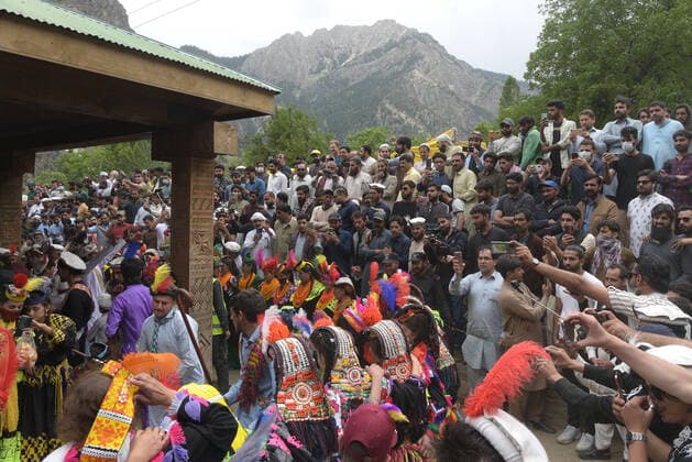Pakistan: Chilmjushi Festival in the Kalsh Valley Kalashi women and men wearing traditional dresses participating in the dance during the Chilmjushi Festival in the Kalsh Valley. Chilum Joshi is also known as a Kalash spring festivals. Dressed up in newly knitted clothes with elaborate headgear and jewelry in vibrant colors , Kalasha women dance to traditional drumbeats during the chilum joshi festivals that concluded here at the scenic Bamburet valley on Sunday with fanfare. The four days event attracted an unprecedented number of tourists including a group of 22 Malaysian motorcyclists, besides the French, Australian and Italian nationals, on the concluding day of the festival young men women select their life partners while each day f Copyright: RanaxSajidxHussain