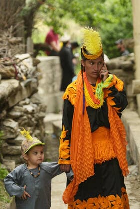 Pakistan: Chilmjushi Festival in the Kalsh Valley Kalashi women and men wearing traditional dresses participating in the dance during the Chilmjushi Festival in the Kalsh Valley. Chilum Joshi is also known as a Kalash spring festivals. Dressed up in newly knitted clothes with elaborate headgear and jewelry in vibrant colors , Kalasha women dance to traditional drumbeats during the chilum joshi festivals that concluded here at the scenic Bamburet valley on Sunday with fanfare. The four days event attracted an unprecedented number of tourists including a group of 22 Malaysian motorcyclists, besides the French, Australian and Italian nationals, on the concluding day of the festival young men women select their life partners while each day f Copyright: RanaxSajidxHussain