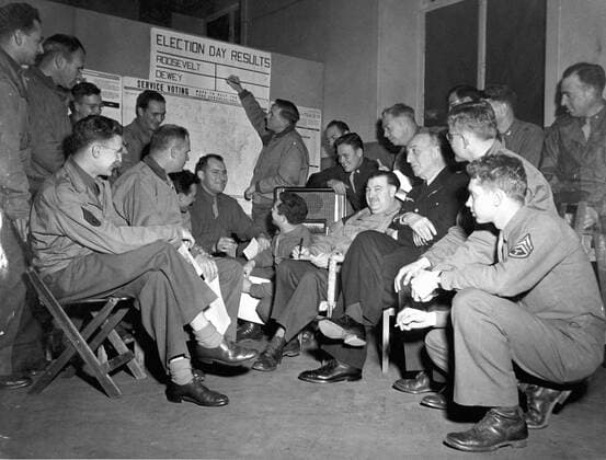 U.S Presidential Election somewhere in France (November6,1944) An U.S officer places early election results on a tally board while others officers listen to the news over the radio.Two French liaison officers can be seen in the group.(U.S Presidential Election,somewhere in France November 6,1944) Copyright: xPhoto12 Coll-DITE USISx DIT01037_182
