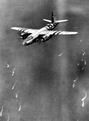 An American B-26 Marauder en route to attack gun installations on coast of Normandy, June 6, 1944 Boaring special striped markings on wings and fuselage, a B-26 Marauder of the 9th U.S. Air Force charges at low altitude over the English Channel June 6, 1944, to attack gun installations and coastal defenses while landing craft below head toward the Normandy coast (France) . Copyright: xPhoto12 Coll-DITE USISx DIT01103_158