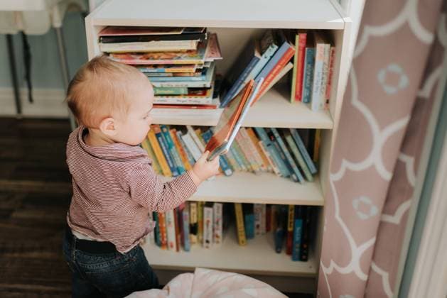 Baby boy in living room removing story book from bookshelves, 05.03.2019, Copyright: xSaraxMonikax, model released, , property released, 12 to 15 months,at home,baby,baby boy,book,bookshelf,casual clothing,child,childhood,choosing,concentration,curiosity,cute,independence,indoors,innocence,jeans,learning,leisure,lifestyle,living room,male,March 2019 Release,one person,only male,only one baby boy,playing,real people,removing,shirt,side view,storybook,three quarter length,wearing,Playing,Removing,Thinking,Concentration,Learning,Child,Baby,Male,Boys,Baby Boy,Childhood,Choice,Decisions,Curiosity,Cute,Independence,Innocence,One Person,Three Quarter Length,Side View,Book,Furniture,Storage Furniture,Bookcase,Casual Clothing,Trousers,Jeans,Shirt, IS09BY59Z