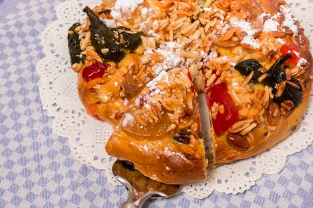 Portuguese King Cake is a famous christmas celebration cake with dry nuts and crystalized fruits. , 25769748.jpg, almond, background, baked, bakery, cake, christmas, colorful, crystallized, cuisine, dry, fig, fluffy, food, fruit, gastronomy, glace, grape, icing, isolated, king, nut, pastry, pine, pinea, pinus, portugal, portuguese, raisin, round, seasonal, seed, sugar, sweet, tasty, top, tradition, traditional, typical, view, white, xmas, cloth, table,