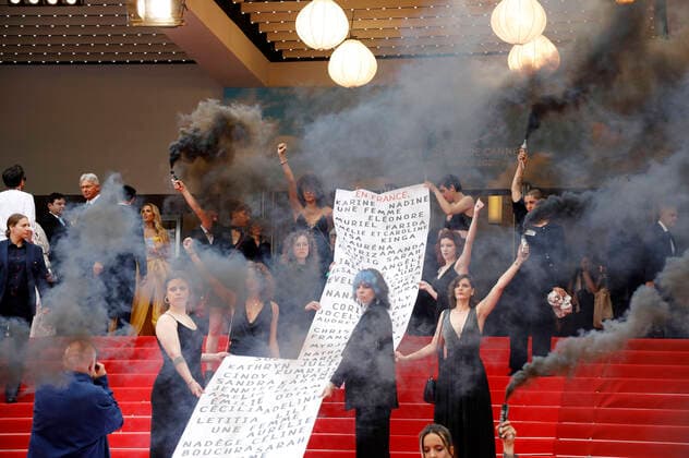 Mitglieder der feministischen Bewegung Les Colleuses halten ein Transparent mit den Namen von 129 Frauen, die seit den letzten Filmfestspielen in Cannes an häuslicher Gewalt gestorben sind, bei der Premiere des Kinofilms Holy Spider Les nuits de Mashhad auf dem Festival de Cannes 2022 75. Internationale Filmfestspiele von Cannes im Palais des Festivals. Cannes, 22.05.2022