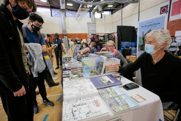 (220522) -- VANCOUVER, May 22, 2022 -- A comic artist talks with visitors at a booth during the Vancouver Comic Art Festival in Vancouver, British Columbia, Canada, on May 22, 2022. The Vancouver Comic Art Festival, an annual celebration of comics and graphic novels and their creators, features over one hundred of comic creators from around the world this year. (Photo by Xinhua) CANADA-VANCOUVER-COMIC ART FESTIVAL LiangxSen 